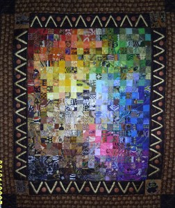 A mosaic art quilt with 2" squares arranged using the VIBGYOR sequence. Size:3x4 ft